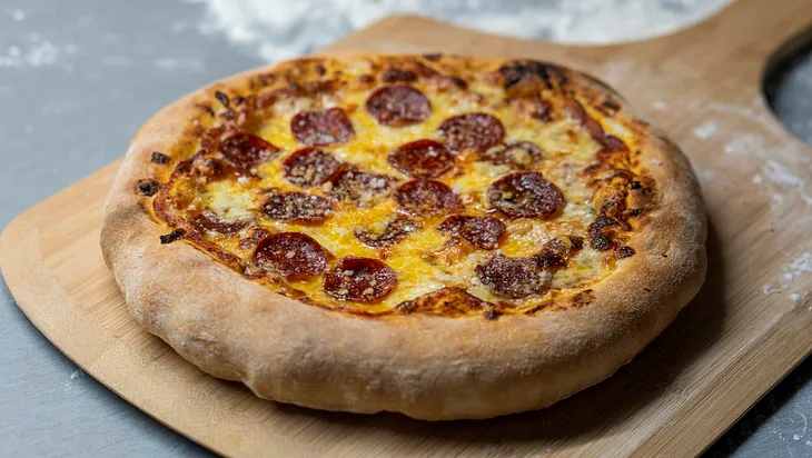 A pizza fresh from the oven with pepperoni instead of bacon.