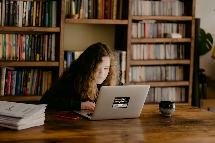 teenage girl at her laptop studying
