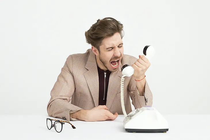 A man yelling down a phone