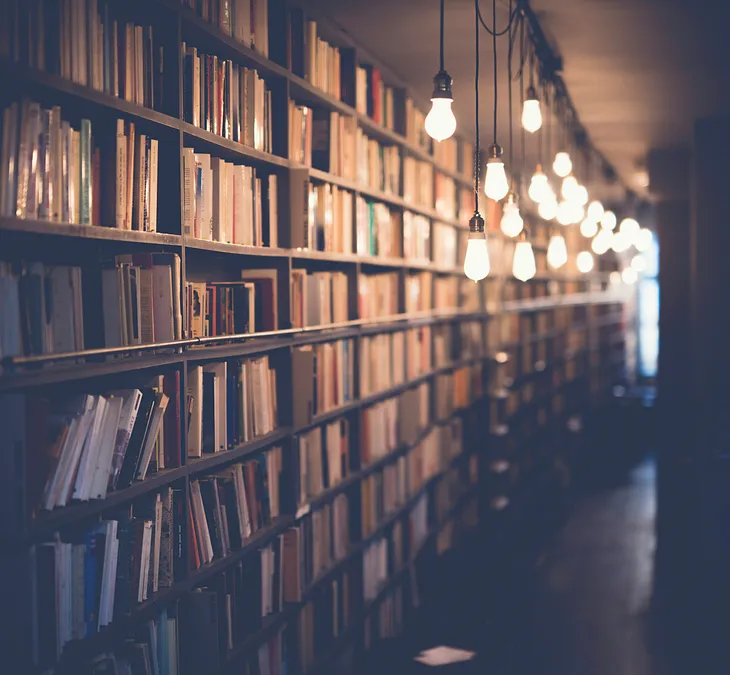 Photo of shelves upon shelves of books down a long corridor