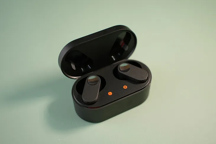 A pair of bluetooth earbuds in the case