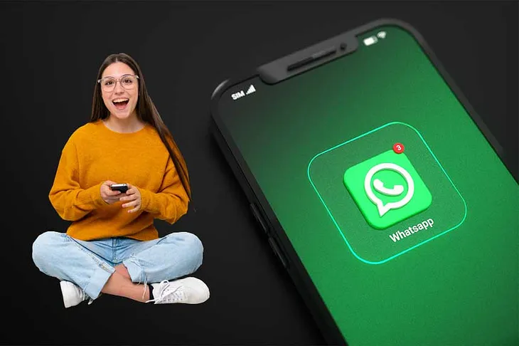 Woman happily holding phone with WhatsApp logo
