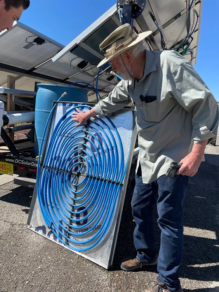 Hill Kemp, co-founder and CTO of ener.com showing the PV Cooling module in Taos, NM last week. This module is installed behind new or existing PV panels in order to increase their performance and life.