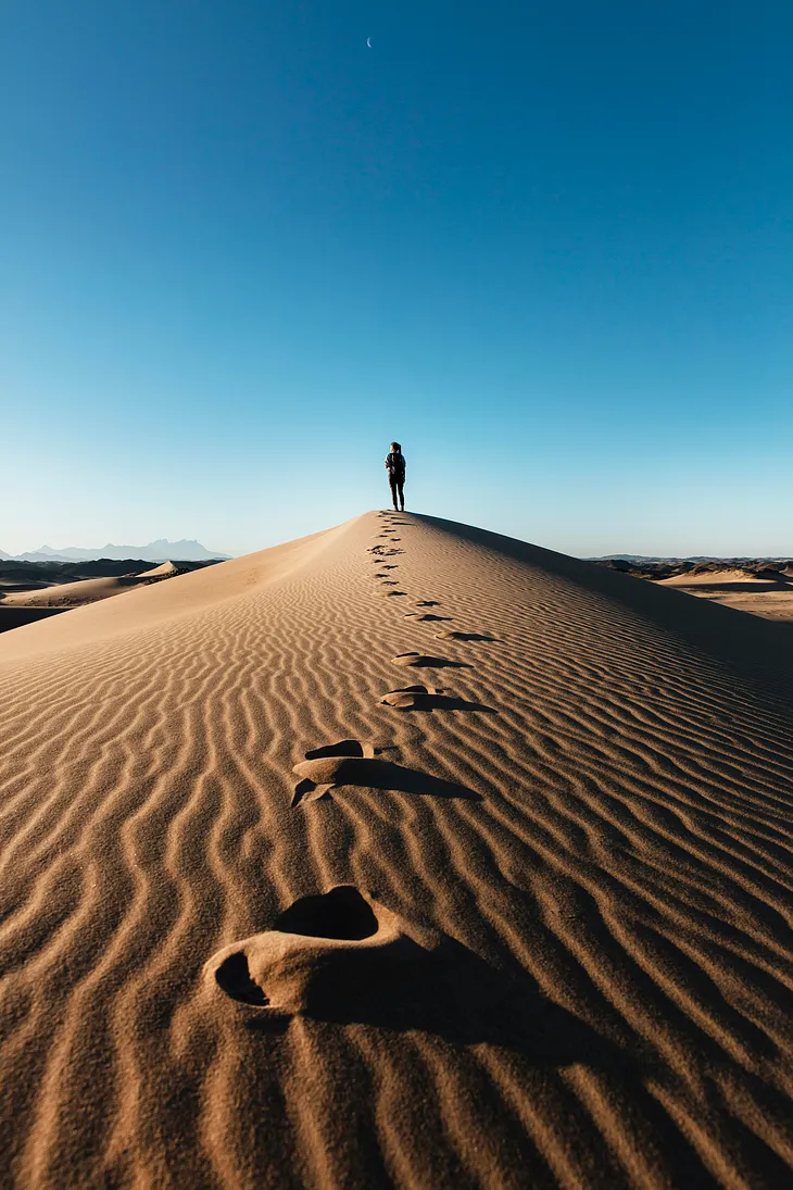 A Lady walking through an unknown valley.