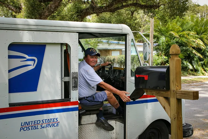 US Postal carrier delivering the mail