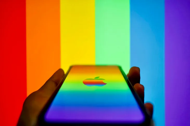 An iphone with a rainbow background