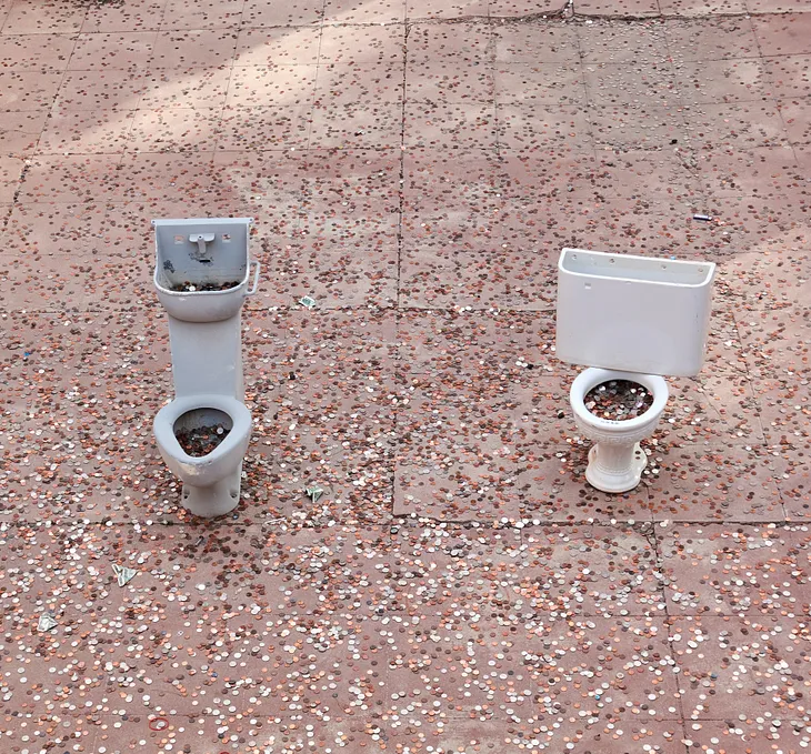 Miniature toilets full of coins