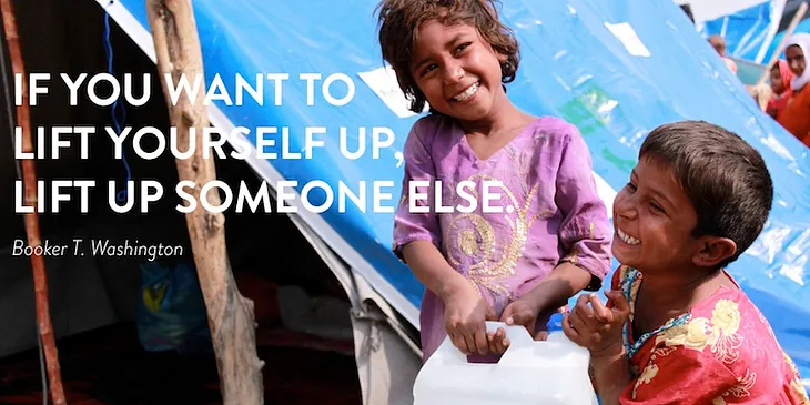 Children smile as they carry a bottle of detergent supplied by U