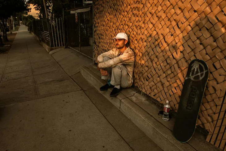 homeless man sitting in alley