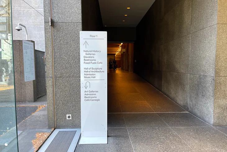 A new sign in front of the passageway that leads from the Carnegie Museum of Art to the Carnegie Museum of Natural History.