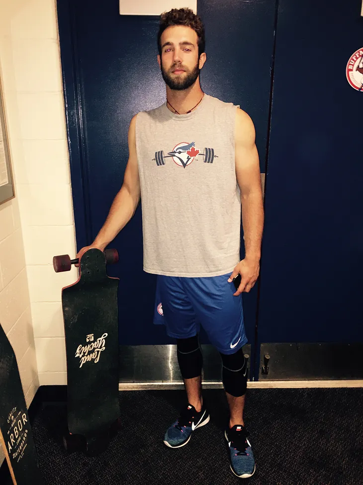 Daniel Norris holds a longboard in May 2015 in the Buffalo Bisons’ clubhouse.