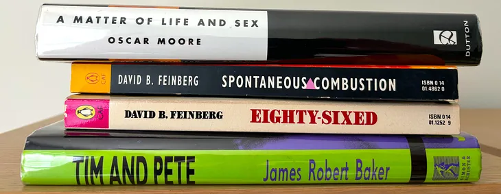 Spines of four novels by Oscar Moore, David B. Feinberg, and James Robert Baker stacked on top of one another.