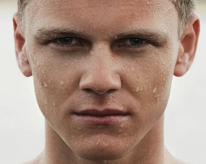 white man with beads of water or sweat on face