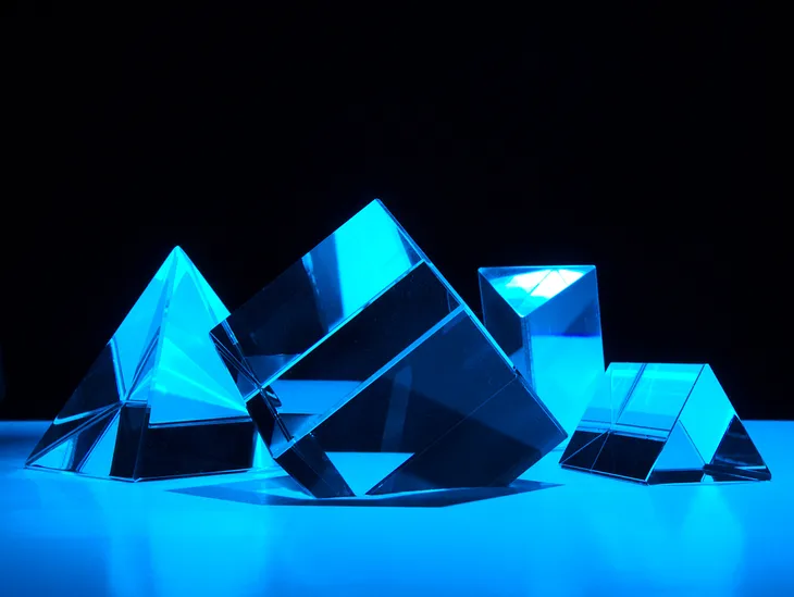 Crystal Night: Crystal cube, pyramid and prisms shot in studio with colored flashes.