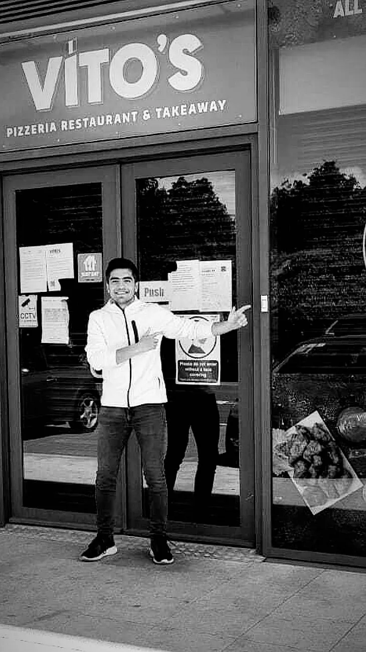 Vagif happily points at his local fish and chips shop