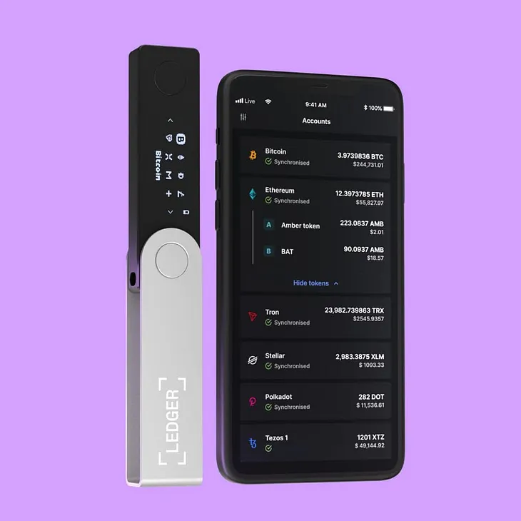 There is a Ledger Nano X Crypto Hardware Wallet and mobile phone with Ledger Live application on the picture