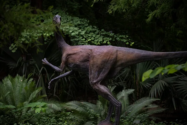 Image of a Velociraptor among greenery.