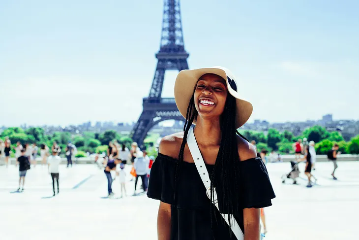 Woman smiling in front of the Eiffel tower France