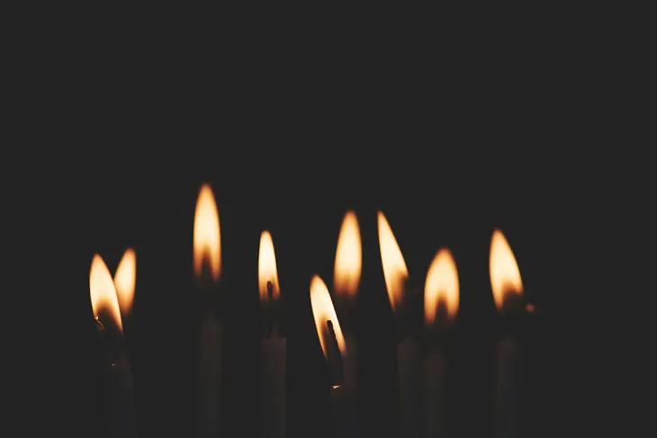 Candles on a cake are illustrating the concepts of fire and living souls