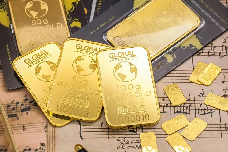 Gold bullion spread over sheet music.