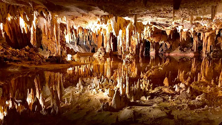 The still waters of the underground lake in the Luray Caverns in Charlottesville, Virginia perfectly mirrors the cavern ceiling above it.