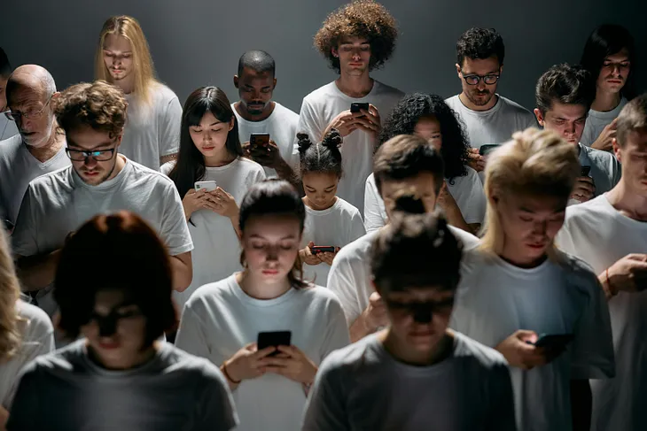 A group of people working with their mobile phones.