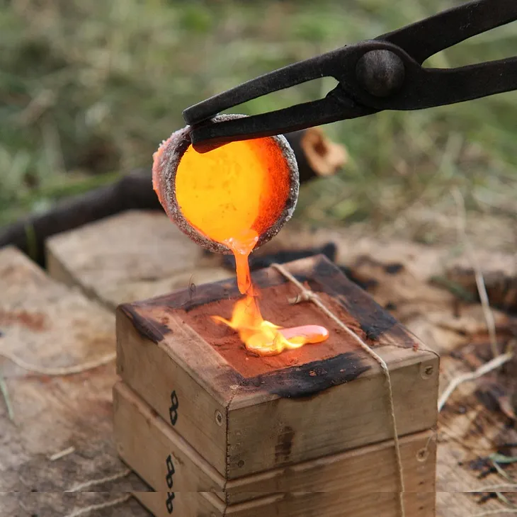 Molten metal being poured from a crucible