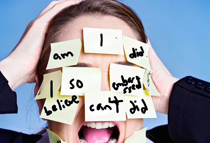 A woman having a mental breakdown with her face covered in Post-it Notes