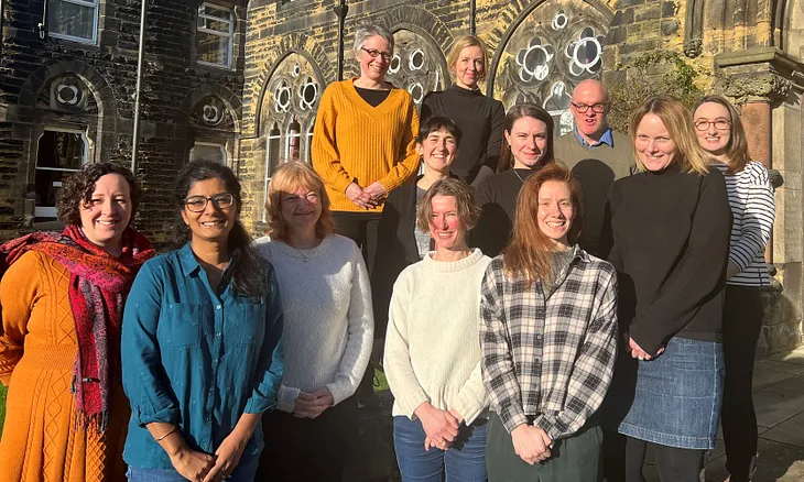 The Horizons Institute team stand together for a photo on the steps of Hinsley Hall in Headingley, Leeds