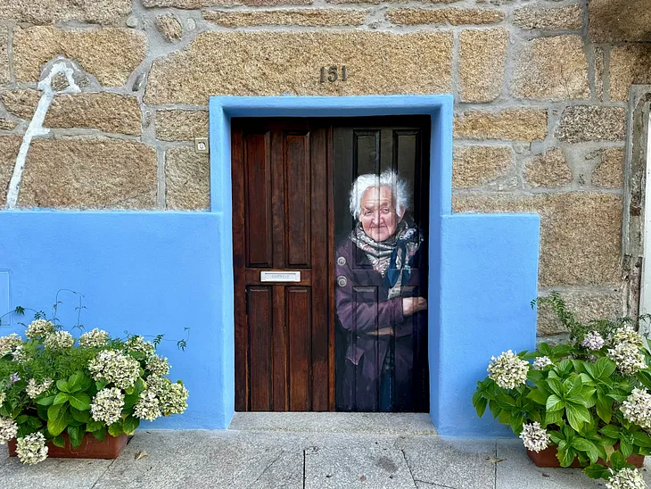 Fresco of an elderly woman framed by plants.