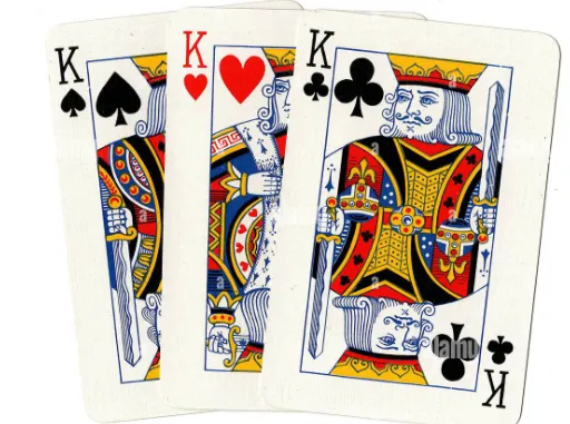 Three playing cards — two black kings and one red one.