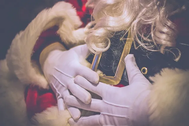 A close-up of Santa’s hands, belt, and beard.