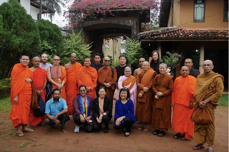 Buddhist monks and nuns pose for photo with Networks for Peace members.