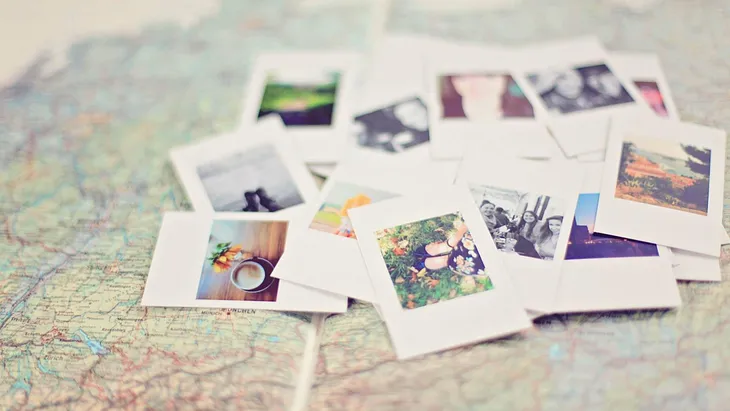 Pile of photos on a map.
