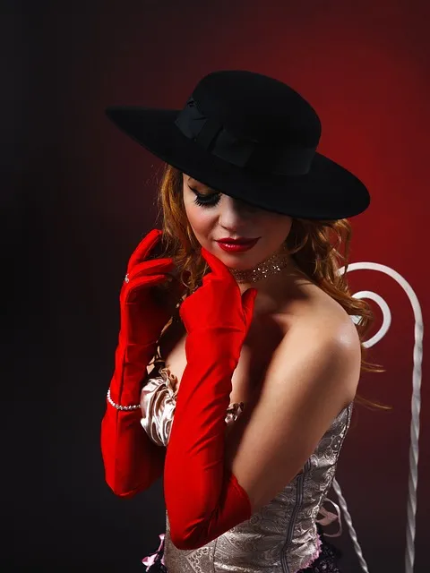 Woman wears hat, long gloves, strapless bustier, burlesque style