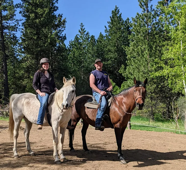 Author and her partner on horseback, having just returned from a summertime ride.