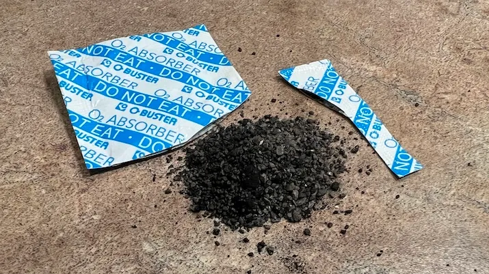 A cut-open oxygen absorber showing its contents