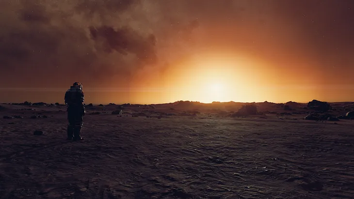 Screenshot of image taken in Starfield’s photo mode with playable character in a space suit to the left with back facing the camera, facing towards a bright sunrise on a barren landscape on Mercury.