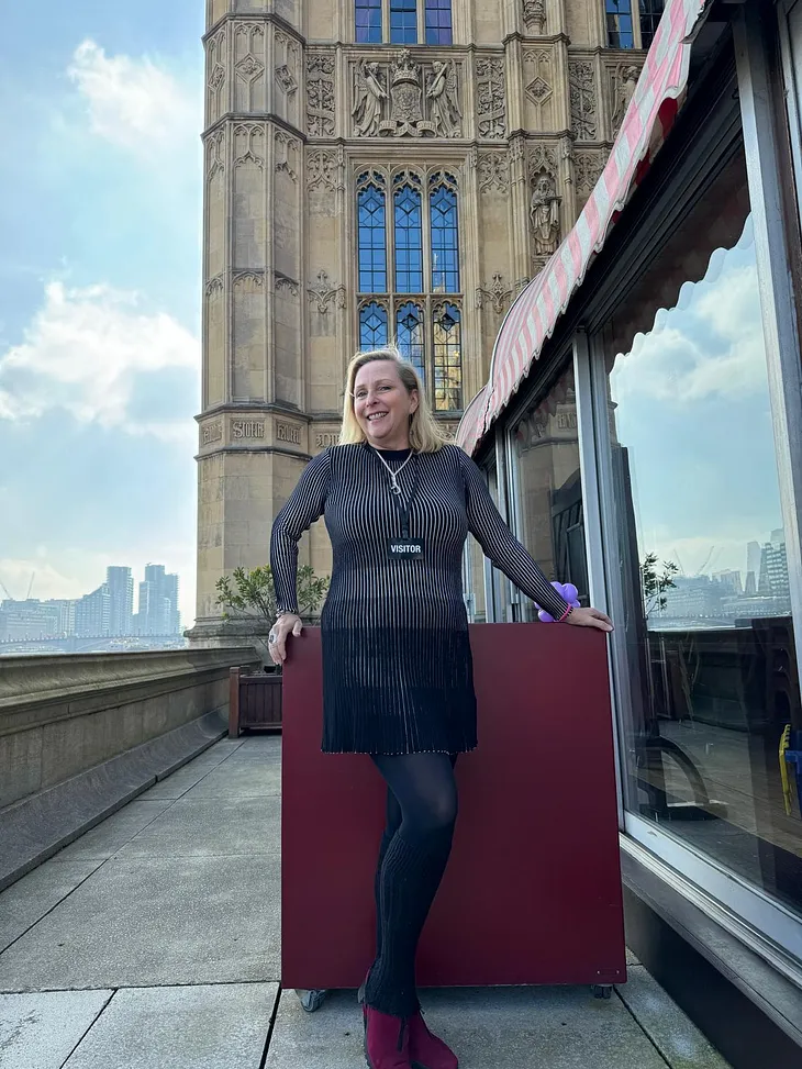 Middle Aged Female Standing in Front of The House of Lords by The Thames