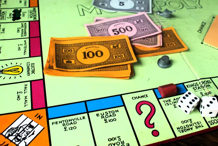 A Monopoly board with play money and two dice for rolling