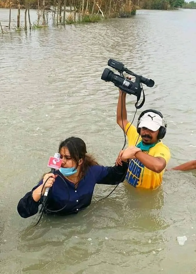 Kolkata TV journalists in Sunderbans Rangabelia village covering the aftermath of Cyclone Amphan in West Bengal, India.