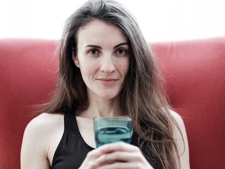 an image of a person smiling while drinking water or engaging in a light activity like walking. This image should convey a sense of positivity and ease, setting the tone for the article.