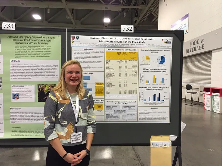 The author stands in front of a poster on “Consumer Discussion of DTC Genomic Testing Results with Primary Care Providers”