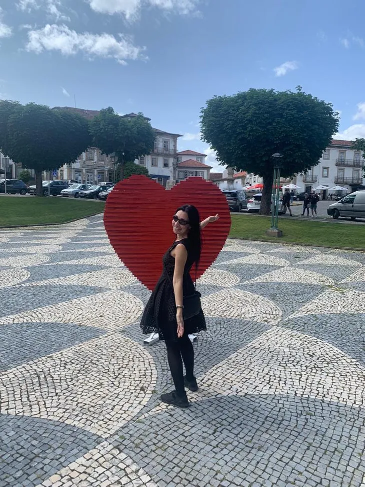 Monção — Portugal — Red Heart with a Smiling Girl in a black dress