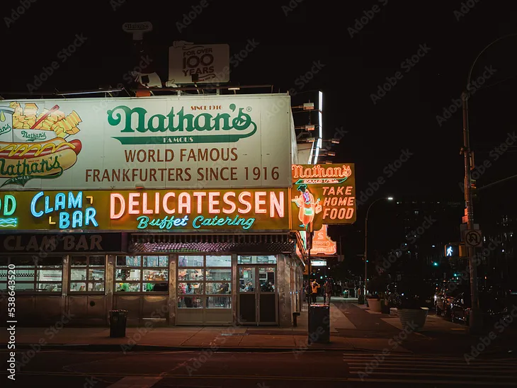 Nathan’s Famous neon sign at night in Coney Island