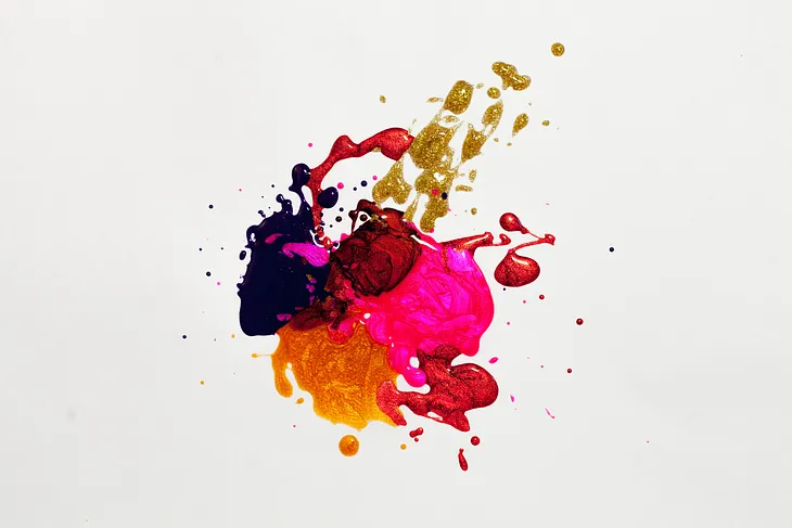A splatter of pink, red, orange and purple paint.
