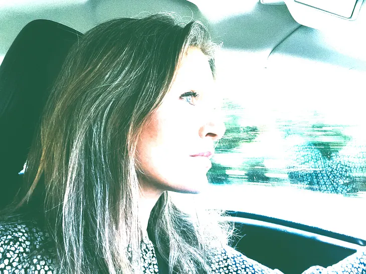 Author profile as she drives in car.
