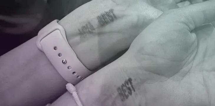 Picture of a stamp on wrist with written best