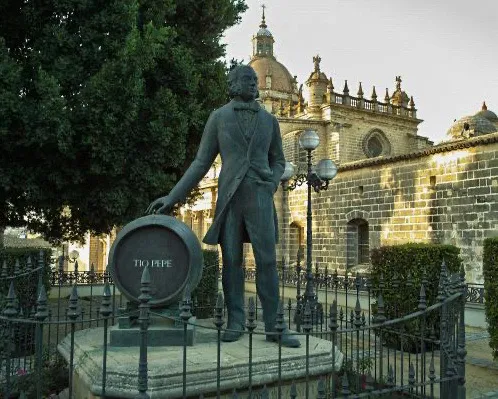 Statute of José Angel de la Pena, standing beside a sherry barrel marked Tio Pepe