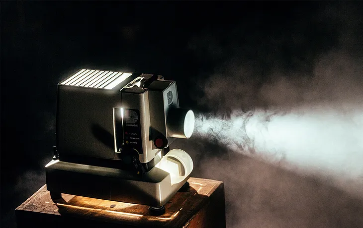 A projector playing film in a dark room.